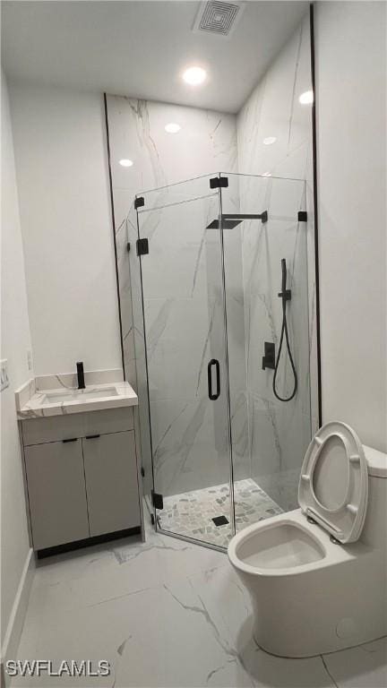 bathroom featuring vanity, an enclosed shower, and toilet