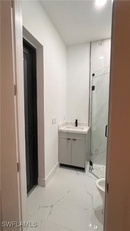 bathroom with vanity, toilet, and a shower with shower door