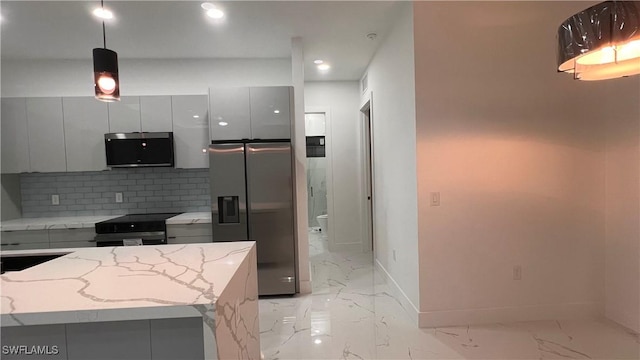 kitchen with light stone countertops, a center island, backsplash, decorative light fixtures, and appliances with stainless steel finishes