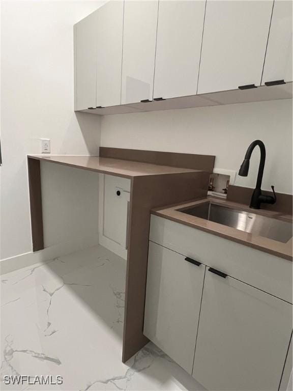 laundry area with cabinets, sink, and hookup for a washing machine