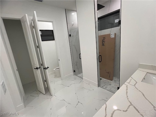 bathroom featuring walk in shower, vanity, and toilet