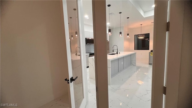 bathroom featuring backsplash and sink