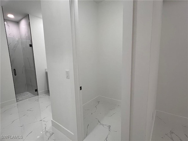 bathroom with a shower with shower door