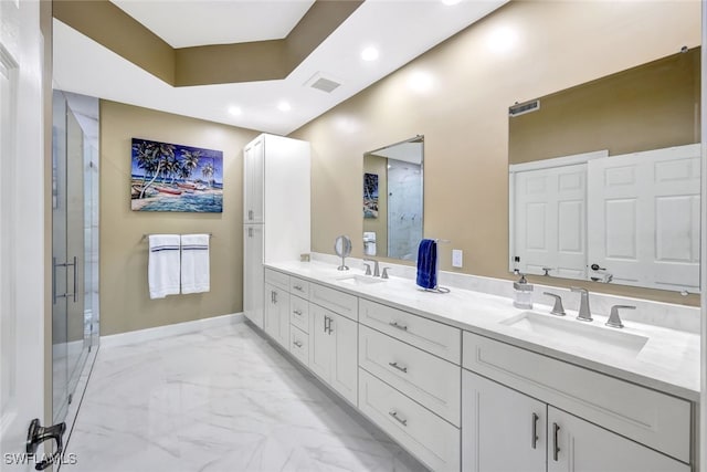 bathroom with vanity and a shower with door