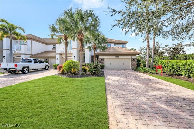 view of front of property with a garage and a front lawn