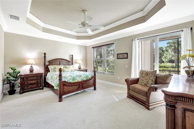 carpeted bedroom with multiple windows, access to outside, a tray ceiling, and ceiling fan