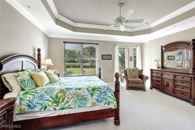 bedroom featuring access to exterior, ornamental molding, a tray ceiling, light colored carpet, and ceiling fan