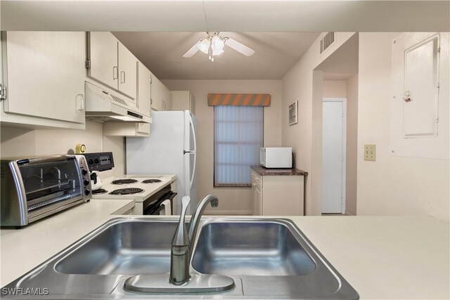 kitchen with white appliances, electric panel, white cabinets, sink, and ceiling fan