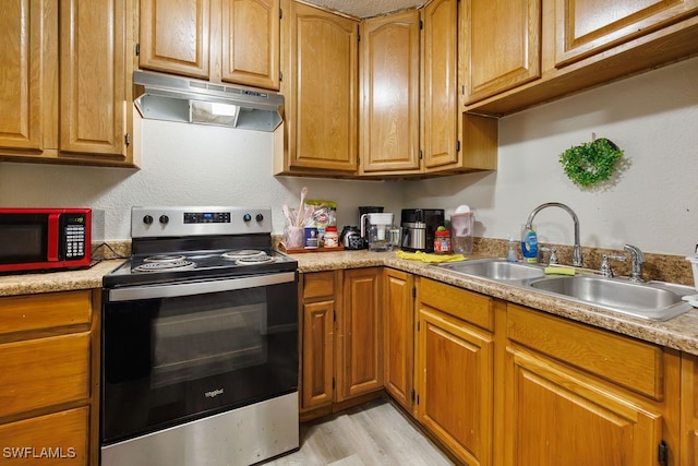 kitchen featuring light wood-type flooring, electric stove, and sink