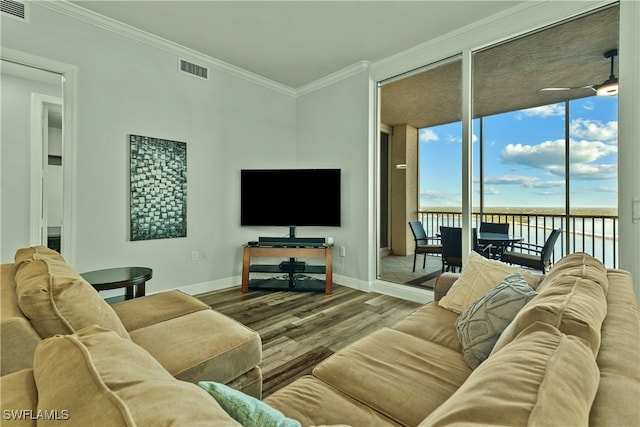 living room featuring hardwood / wood-style floors, expansive windows, ceiling fan, and crown molding