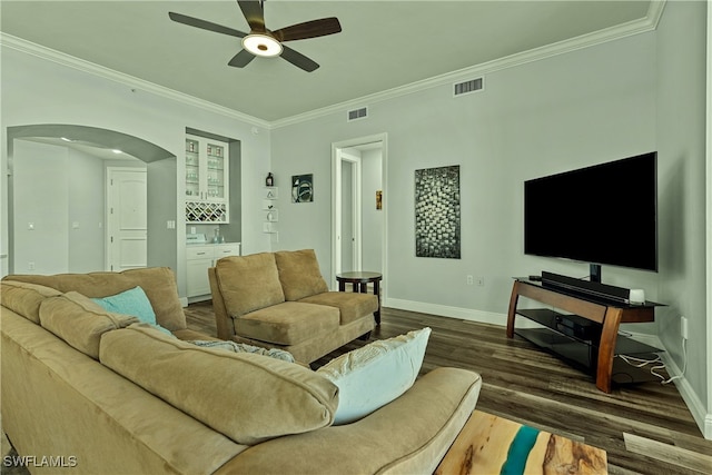 living room featuring ceiling fan, dark hardwood / wood-style flooring, and ornamental molding