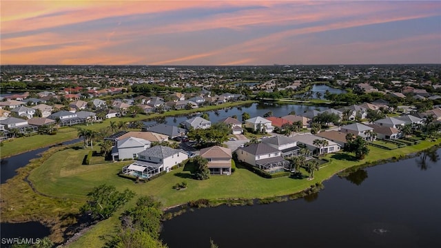 aerial view at dusk with a water view