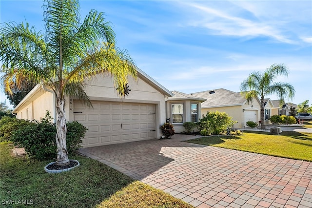 ranch-style house with a garage and a front lawn