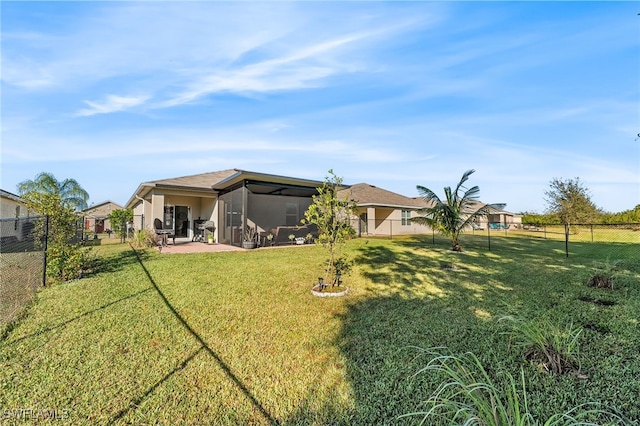 back of property featuring a lawn and a patio