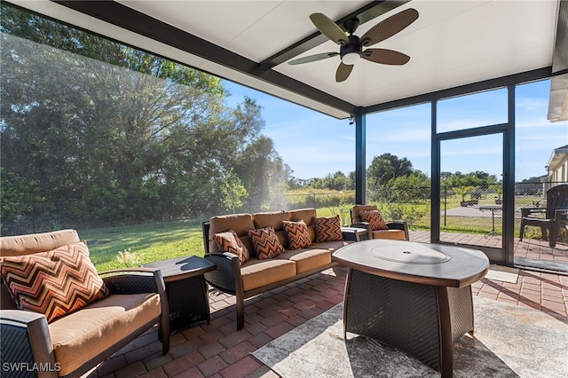 sunroom featuring ceiling fan