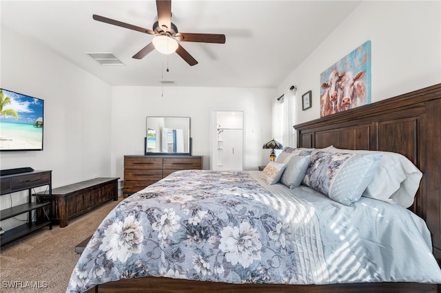 bedroom with ensuite bath, ceiling fan, and light carpet