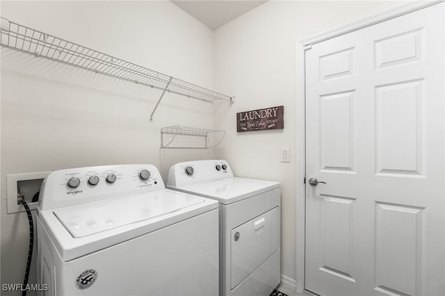 laundry room with washing machine and clothes dryer