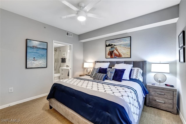 bedroom featuring ensuite bath, baseboards, visible vents, and light colored carpet