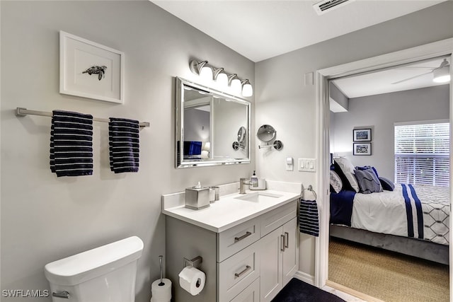 ensuite bathroom with ensuite bathroom, visible vents, vanity, and toilet