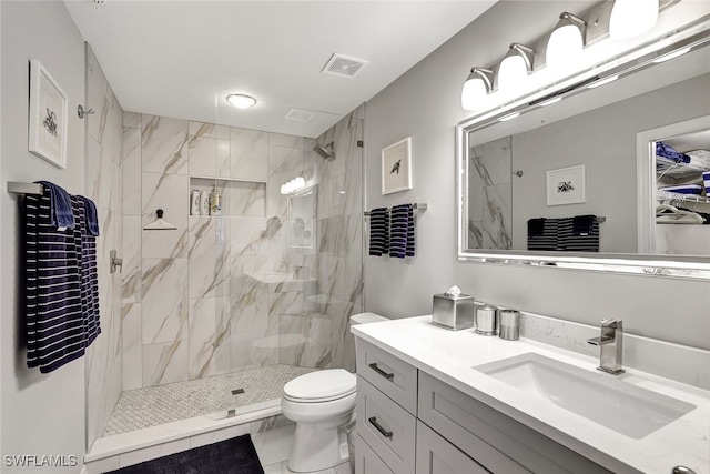 bathroom with visible vents, toilet, marble finish floor, vanity, and a shower stall