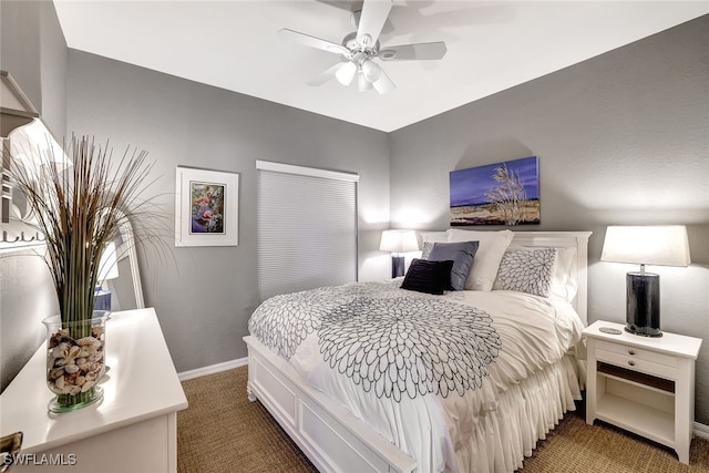 bedroom featuring ceiling fan, dark carpet, and baseboards