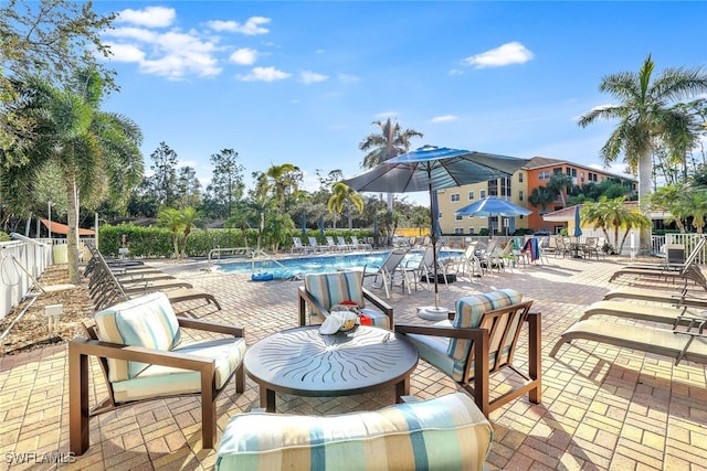 view of patio / terrace featuring fence and a community pool