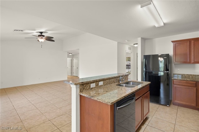 kitchen featuring black fridge, sink, stainless steel dishwasher, ceiling fan, and light stone countertops