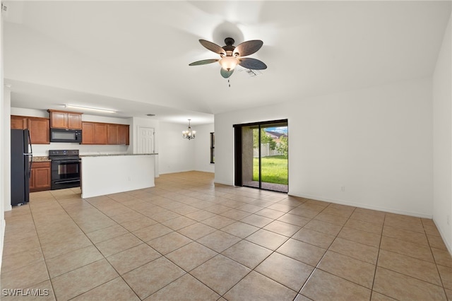 unfurnished living room with ceiling fan with notable chandelier and light tile patterned floors