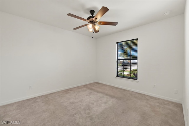 empty room with light colored carpet and ceiling fan