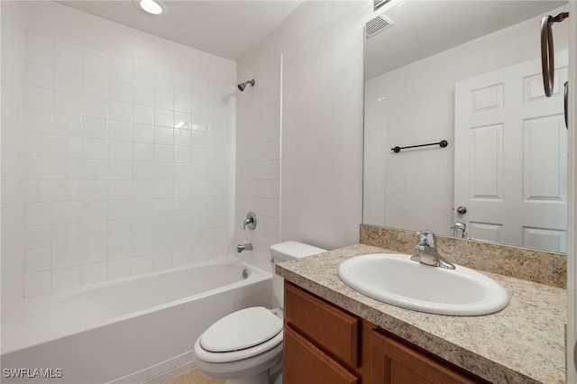 full bathroom with vanity, toilet, and tiled shower / bath