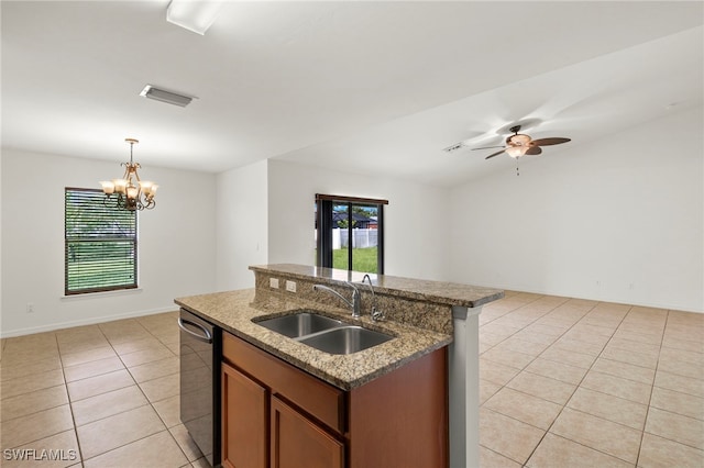 kitchen with sink, light tile patterned floors, decorative light fixtures, a center island with sink, and dishwasher