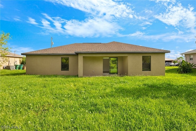 rear view of house with a yard