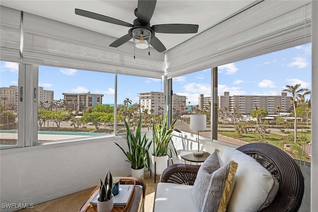 sunroom / solarium featuring ceiling fan