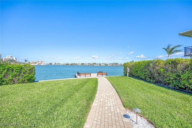 exterior space with a lawn and a water view