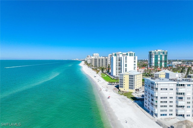 drone / aerial view featuring a water view and a beach view