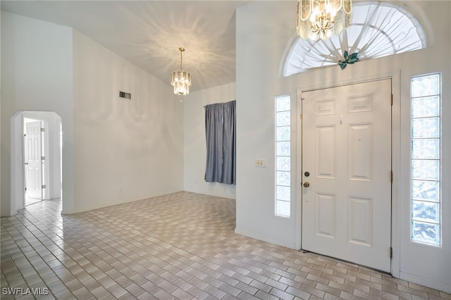 entrance foyer with a healthy amount of sunlight and a notable chandelier