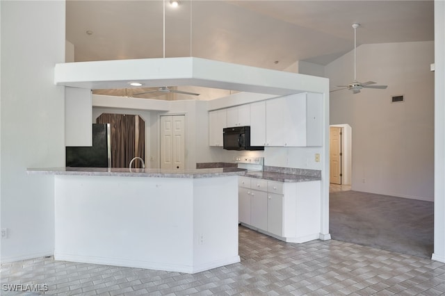 kitchen with light carpet, high vaulted ceiling, black appliances, ceiling fan, and white cabinetry