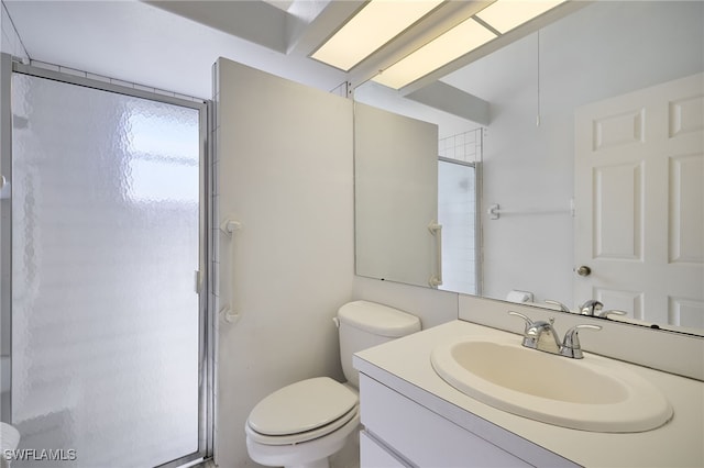 bathroom with vanity, toilet, and a shower with shower door