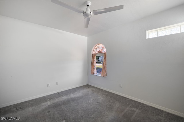 carpeted spare room with ceiling fan