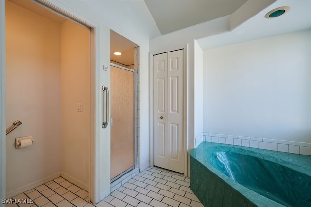 bathroom with tile patterned floors and separate shower and tub