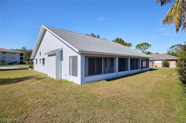 rear view of house with a yard