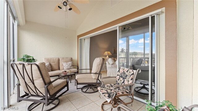 sunroom with ceiling fan and vaulted ceiling