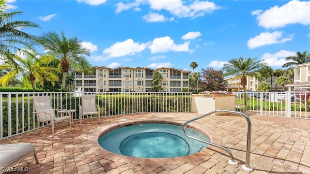 view of swimming pool featuring a community hot tub