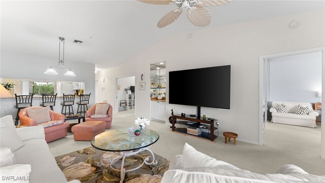 carpeted living room with ceiling fan and lofted ceiling