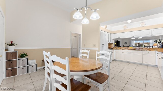 tiled dining space with an inviting chandelier