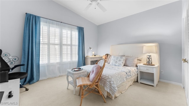 carpeted bedroom with ceiling fan and lofted ceiling