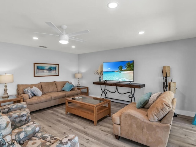 living room featuring light hardwood / wood-style floors and ceiling fan