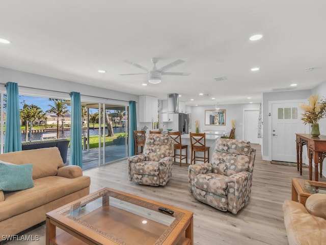 living room featuring light hardwood / wood-style floors and ceiling fan