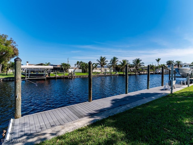 dock area featuring a water view and a yard