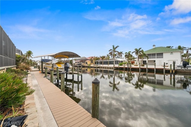 2405 Cherimoya Ln, Saint James City, FL 33956 - dock area with boat lift, a water view, and a residential view